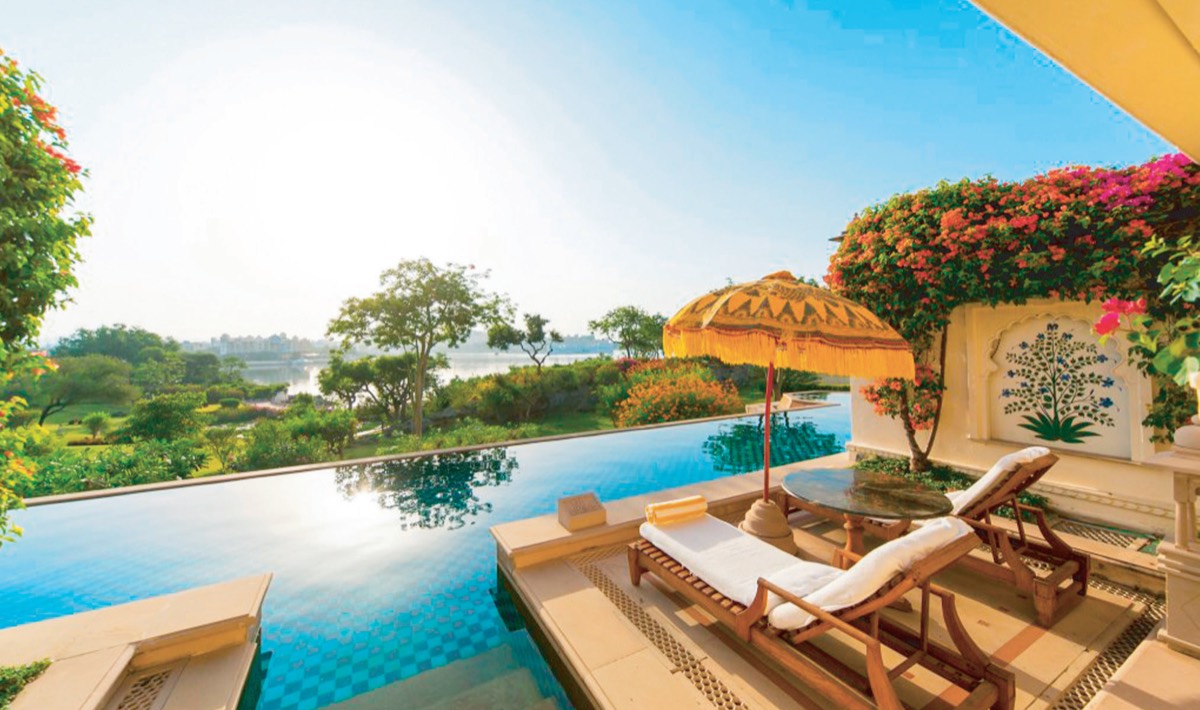 Infinity pool overlooking a lake at a luxury resort